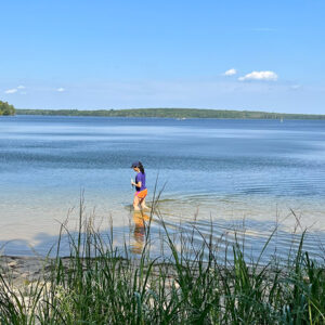 Student stands in Douglas Lake. 