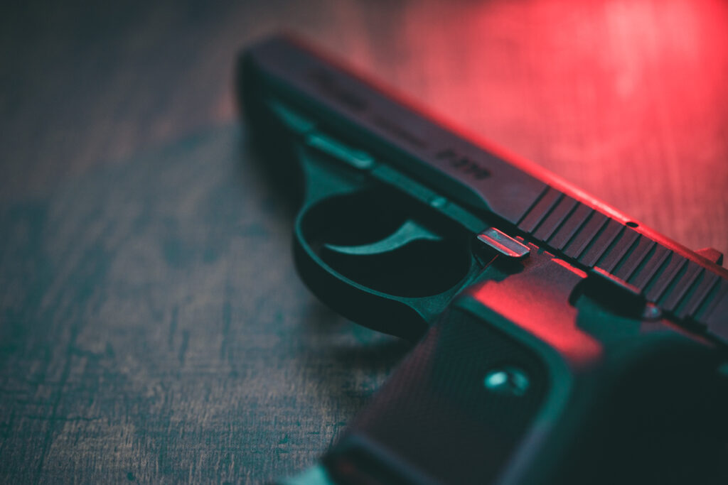 Semi automatic hand gun and red light. Image credit: iStock