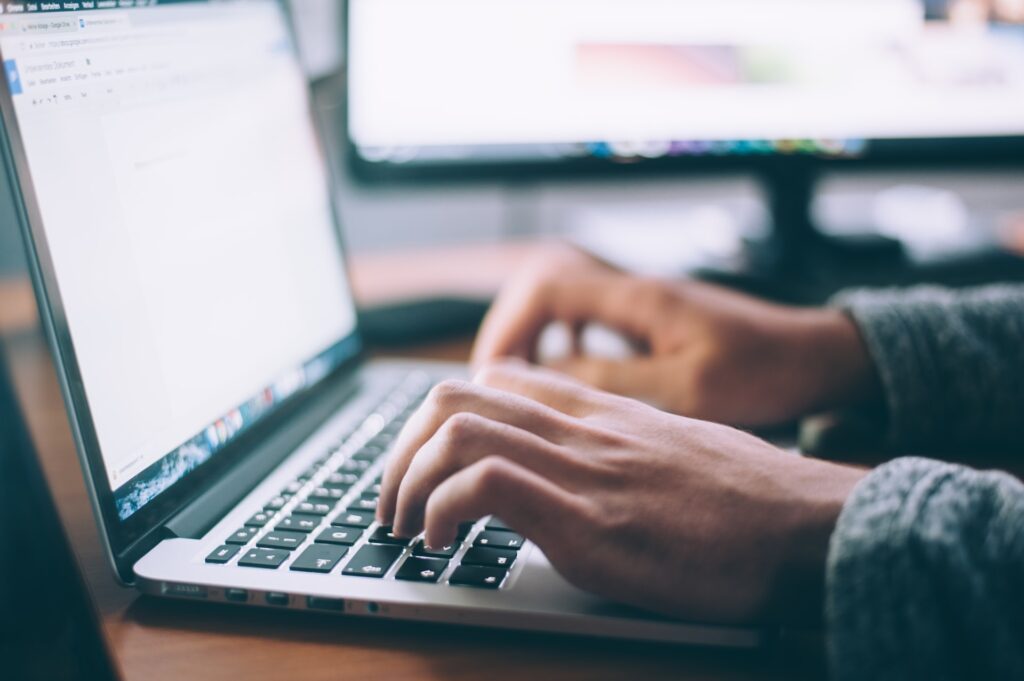 A person using a laptop computer. Image credit: Glenn Carstens-Peters, Unsplash.com