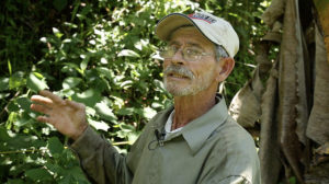 Puerto Rican farmer Don Julio talks about the losses he suffered after Hurricane Maria wiped out his coffee farm last year. Due to labor shortages in agriculture, he spends most of the day cleaning up the 5.5 acres of land himself. Photo credit: Levi Stroud.