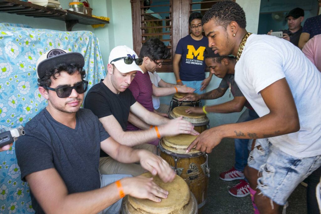 Students (seated) being taught by members of Los Muñequitos de Matanzas