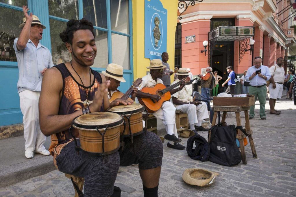Student Michael Gardner plays bongos with a street band in Havana