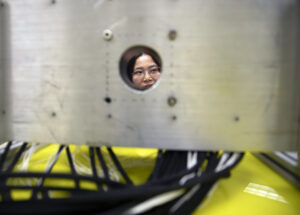 Zhen Xu,Professor of Biomedical Engineering at the University of Michigan is seen through the 700kHz, 260-element histotripsy ultrasound array transducer used in Prof. Xu’s lab. Image credit: Marcin Szczepanski/Lead Multimedia Storyteller, Michigan Engineering