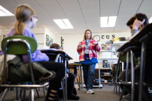 Amy Klopf, a sixth grade teacher at Coleman Elementary, reviews science and sustainability lessons with her students before taking them outside for hands-on and place-based lessons. Image credit: Eric Bronson, Michigan Photography