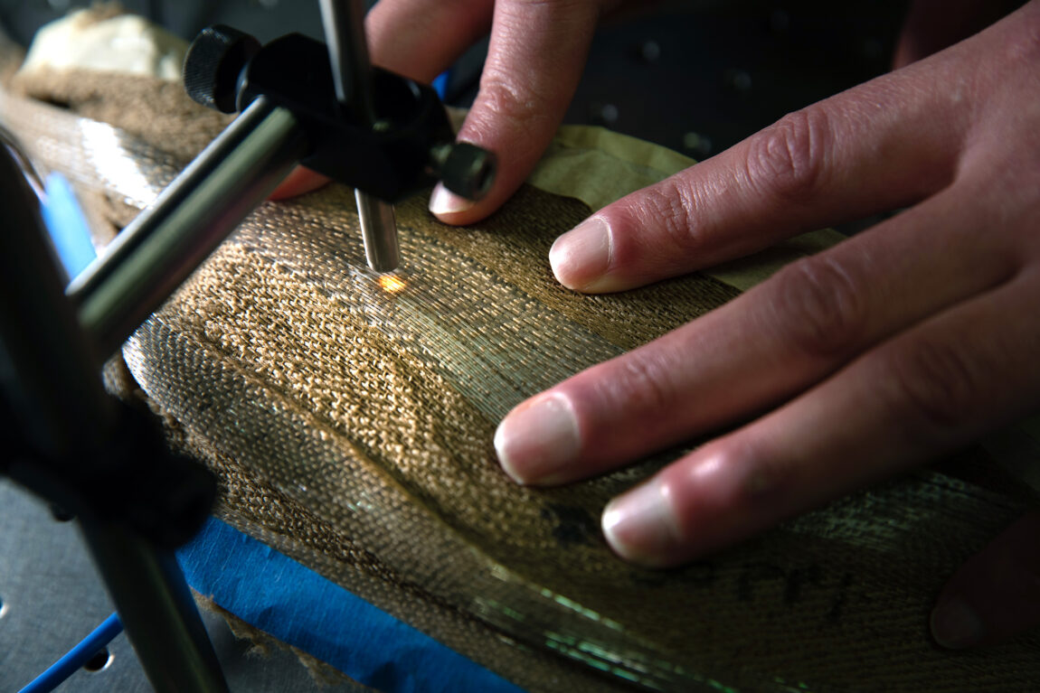 Brian Iezzi scans and measures the photonic fibers in the fabric. (Photo by Marcin Szczepanski, College of Engineering)