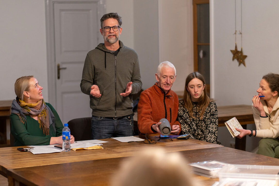 Photo of Paul Draus standing at a table with four other people