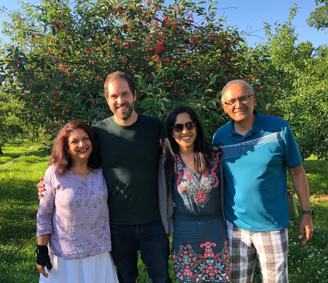 Attia Qureshi, a lecturer at the Gerald R. Ford School of Public Policy, second from right, is pictured with her husband, Isaiah Wunsch, second from left, and her parents. Qureshi helps operate Wunsch Farms in northern Michigan. (Photo courtesy of Attia Qureshi)