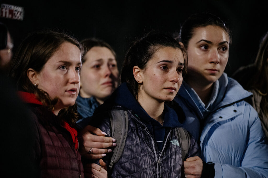 From left, Ford junior Katie Burgin, 21, LSA sophomore Ariana Herman, 20, and LSA sophomore Isabella Michaelis, 21, mourn the Michigan State University students who were killed and injured during a mass shooting earlier this week on Wednesday, Feb. 15, 2023.