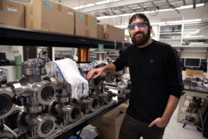 Brian Iezzi poses for a portrait with the photonic fibers fabric he developed. Image credit: Marcin Szczepanski/Lead Multimedia Storyteller, University of Michigan College of Engineering