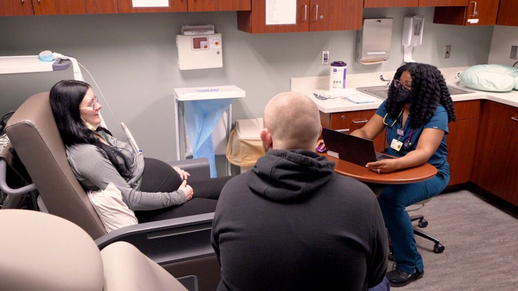 Dr. Shimia Isaac at her family medicine practice in Lansing meets with a pregnant patient. When patients are in crisis, she turns to a service called MC3. Based at the University of Michigan Department of Psychiatry, the program lets providers turn to U-M psychiatrists for rapid and confidential advice on treating a patient's mental health needs. Image credit: Eric Bronson, Michigan Photography