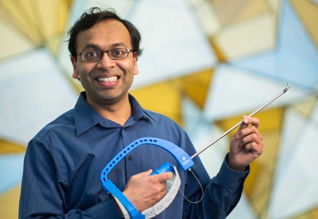 Shorya Awtar holds the FlexDex surgical device he invented. He was elected into the NAE for "inventing and commercializing game-changing surgical products that have made minimally invasive surgery affordable and accessible around the world." Image credit: Shorya Awtar