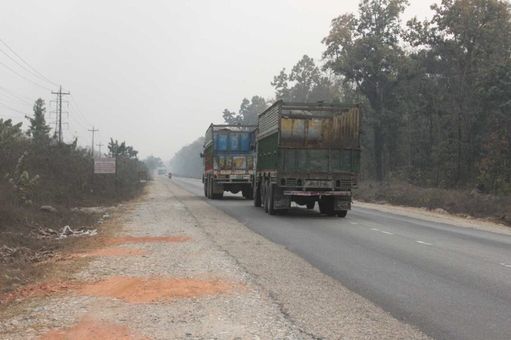 Truck traffic on Nepal's East-West Highway, which bisects all of the country's tiger-bearing parks, as well as important habitat corridors and bottlenecks. For their study, University of Michigan researchers and colleagues equipped two wild tigers, one male and one female, with GPS collars to record detailed information about their movements and behaviors near the highway prior to a planned lane-expansion project. Image credit: Krishna Hengaju
