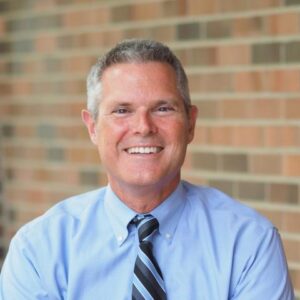 Robert Ernst, Chief Health Officer, Associate Vice President for Health and Wellness in Student Life, and Executive Director of University Health Service. He's wearing a blue shirt and a striped tie.