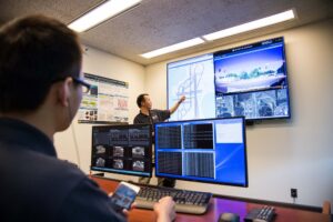 Henry Liu, a professor of Civil and Environmental Engineering and the director of the Center for Connected and Automated Transportation, shows off part of the Michigan Traffic Lab, where simulated connected vehicles can interact with real vehicles inside the adjacent Mcity Test Facility.