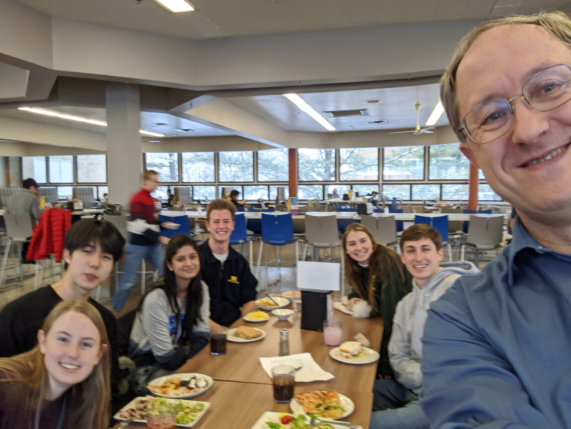 Frank Marsik, lecturer IV in climate and space sciences and engineering in the College of Engineering, takes a selfie with students attending office hours in the dining hall. (Photo courtesy of Frank Marsik)