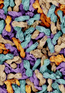 Micron-scale bowties with candy-wrapper twists in a colorized electron microscope image. The ability to control the degree of twist in a curling, nanostructured material could be a useful new tool in chemistry and machine vision. Image credit: Prashant Kumar, Kotov Lab, University of Michigan.