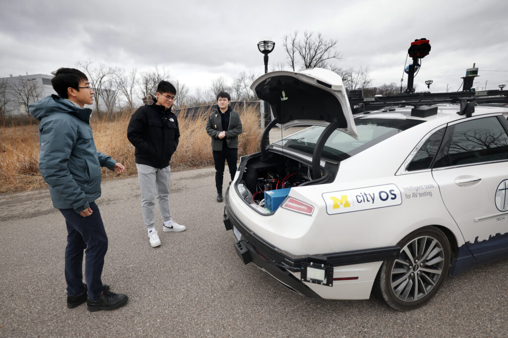 From left, Sean Shen, a research engineer at UMTRI, Xintao Yan and Haowei Sun, both civil engineering PhD students, prepare to take out one of the autonomous vehicles for a test run at Mcity on North Campus of the University of Michigan in Ann Arbor on Wednesday, January 18, 2023. Image credit: Brenda Ahearn/University of Michigan, College of Engineering, Communications and Marketing