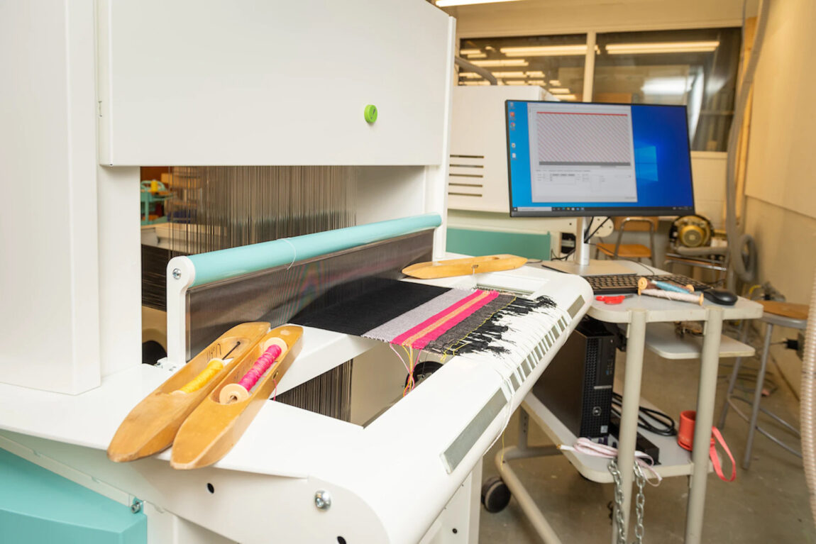 A selection of colorful threads sit on one of the Stamps School’s Thread Controller 2 digital Jacquard looms. (Photo by Scott Galvin)