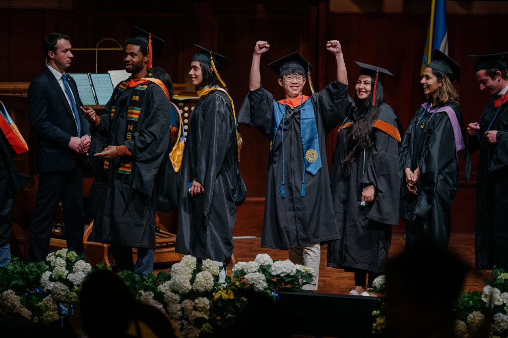 Photo of a master's degree candidate sharing his enthusiasm with the audience.