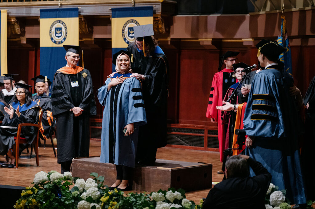 Photo of a graduate receiving her doctoral hood