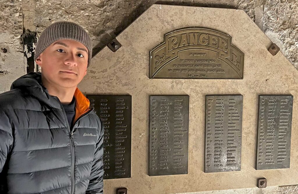 Alexis Gonzalez with memorial plaque at Point du Hoc.