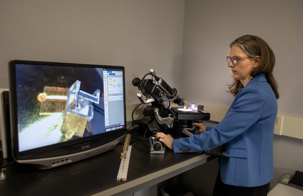Carolyn Kuranz analyzes targets for high-energy laser experiments that will study how radiation affects the evolution of a strong shock wave, which is relevant to phenomenon occurring in accretion disks and inertial confinement fusion systems. Image credit: Marcin Szczepanski, Michigan Engineering