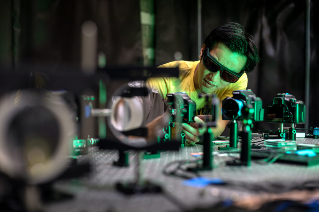 Graduate student Joe Chen works with professor Ryan McBride at the 200-kV, 1-MA, 100-ns MAIZE facility at the Plasma, Pulsed Power, and Microwave Laboratory at the NAME building on the University of Michigan North Campus. Image credit: Marcin Szczepanski, Michigan Engineering
