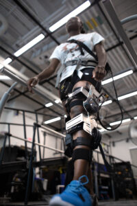 Research subject Therese Nkeng demonstrates an assistive device that might help stroke survivors avoid tripping, slipping or falling while walking. Image credit: Marcin Szczepanski, Michigan Engineering