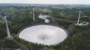 The Arecibo Observatory in Puerto Rico was part of the group of telescopes to use pulsars, an ultra-dense remnant of a massive star's core following its demise in a supernova explosion, to observe low frequency gravitational waves. Image credit: Arecibo Observatory, a facility of the National Science Foundation