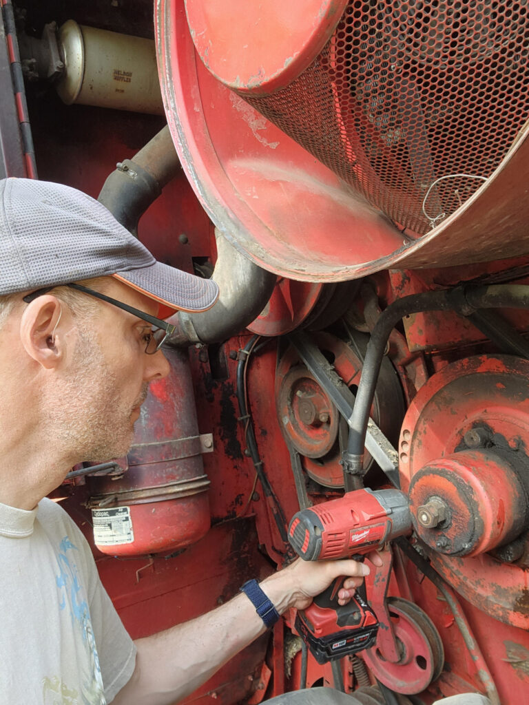 Chris Myers works on a combine that will be entered into the combine demolition derby at the Monroe County Fair. (Photo by Chris Myers)