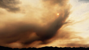 A dark cloud of wildfire smoke rolls over the mountains of British Columbia.