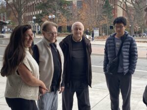 Kopelman and a group of people outside on campus.