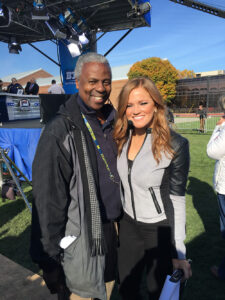 Greg Harden and Michelle McMahon outdoors on a U-M athletics field.
