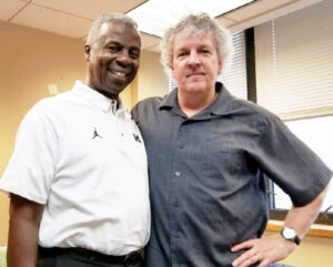 Greg Harden and Steve Hamilton stand side by side. One man is African American, the other is caucasian. Both are dressed casually.