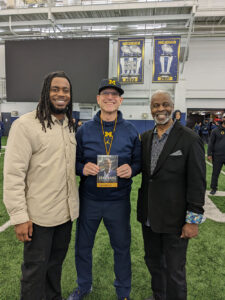 Former Michigan football player Mike Danna and head coach Jim Harbaugh with Harden.