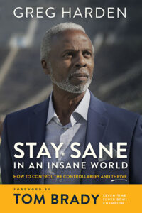 Maize and blue book cover of 'Stay Sane' featuring Greg Harden on the cover. Serious, African-American man with gray hair and beard dressed in blue.