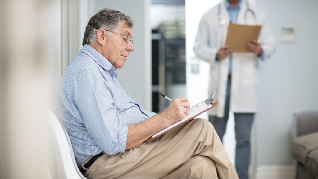 A man filling out a cognitive screening test. Image credit: Getty
