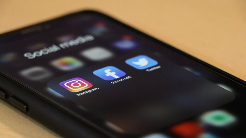 A cell phone displaying social media icons. Image credit: dole777, Unsplash