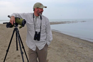 Bryan Pfeiffer at the beach with his camra and a long lens.