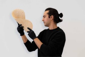 Muhammad Dayyem Khan holding sample of reusable robotic 3D-printed formwork made from upcycled sawdust. Image credit: Tharanesh Varadharajan, Zachary Keller, Muhammad Dayyem Khan
