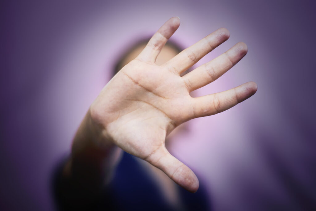 Woman saying stop with hands. Image credit: iStock