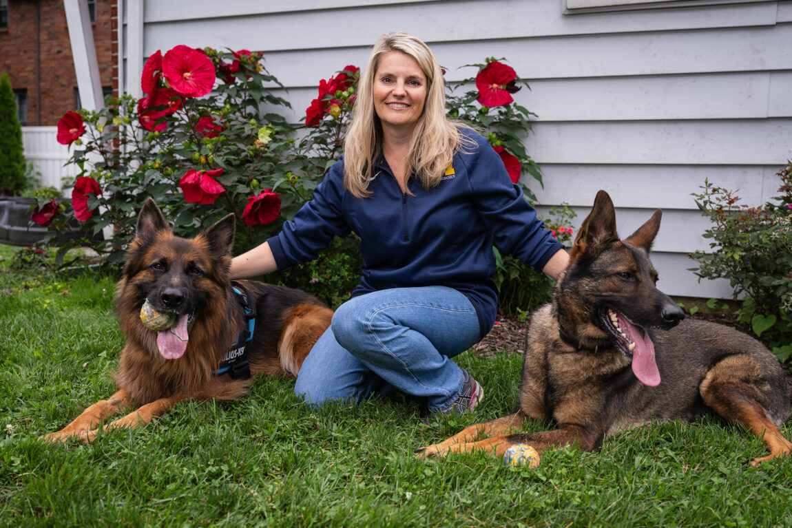 A photo of Casandra Ulbrich between her two dogs