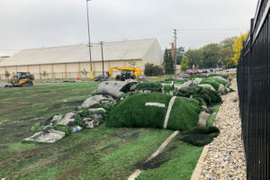 Rolls of sod lined up at Elbel Field as construction for new dorm begins.