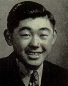 Black & white Headshot of young Asian man smiling.