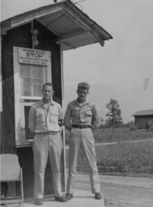 Black & white image of two military men standing side by side.