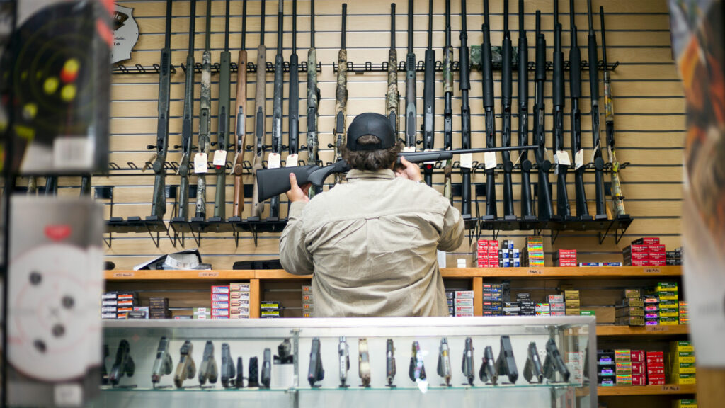 A clerk at a gun shop. Image credit: Getty