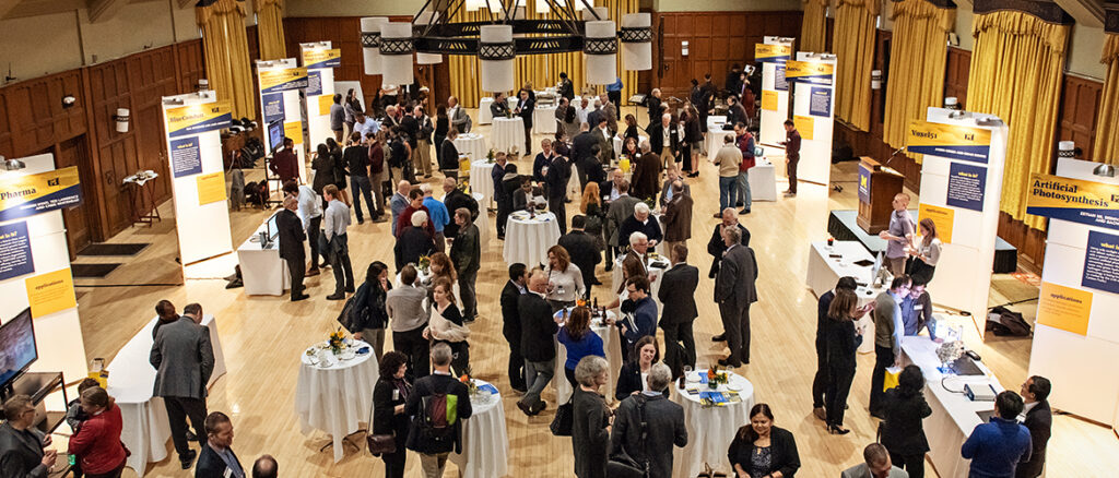 Groups of people mingling around tables at a Celebrate Invention event. Image courtesy: Celebrate Invention