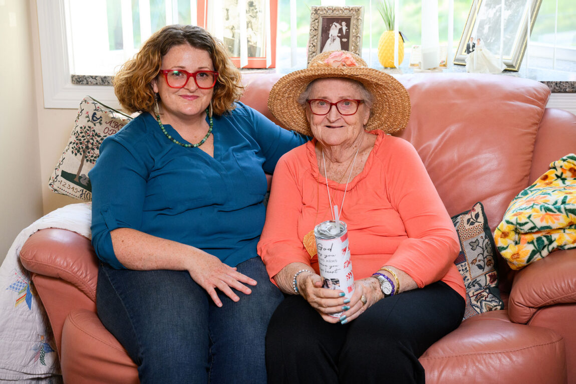 Photo of Mary Schlitt and her mother, Mary Sergent, sitting on a couch.