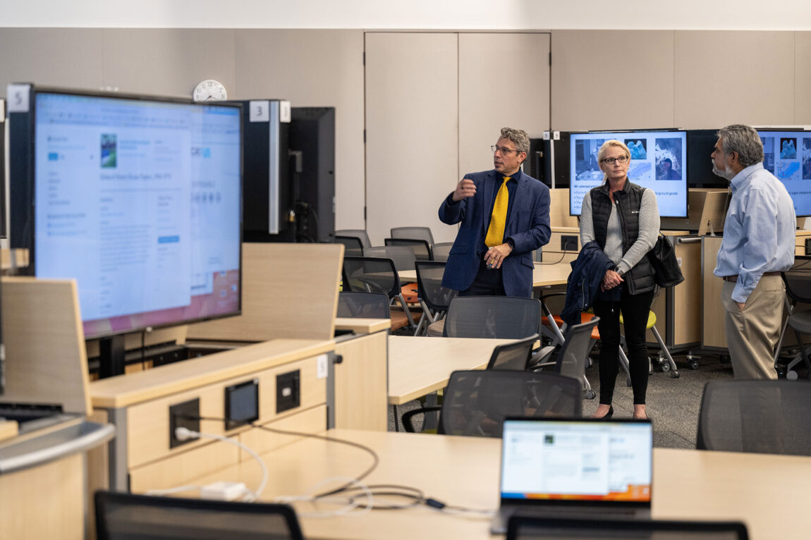 Photo of Mika LaVaque-Manty (left) speaking to attendees at a tour of Kraus Auditorium