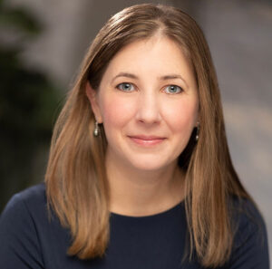 Ariel Djanikian: Headshot of caucasian woman with blue eyes and brown ha